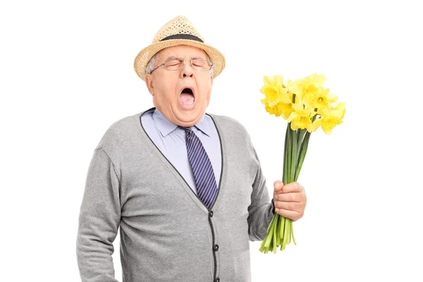 Senior having an allergic reaction to tulips — Stock Photo, Image