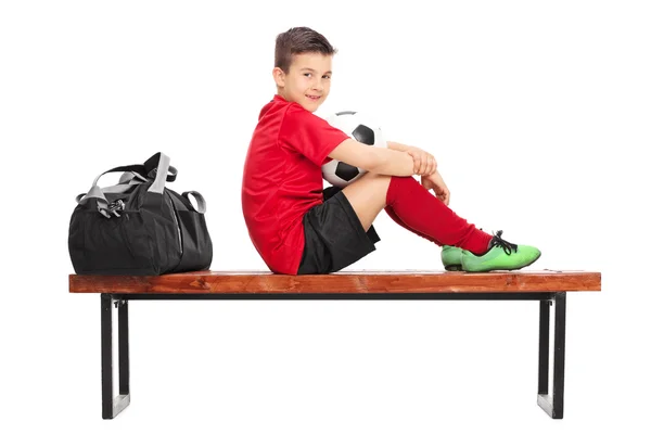 Junior soccer player on bench — Stock Photo, Image