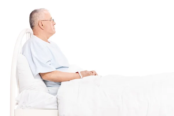 Senior patient lying in a bed — Stock Photo, Image