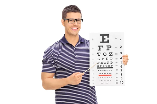 Man with glasses holding eyesight test — Stock Photo, Image