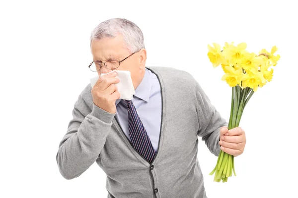 Senior having allergic reaction to flowers — Stock Photo, Image