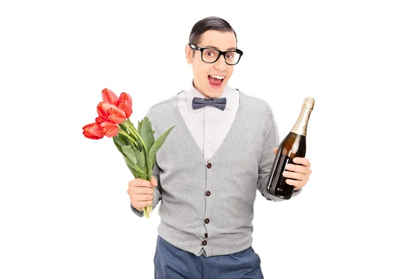 Young man holding tulips and a champagne — Stock Photo, Image