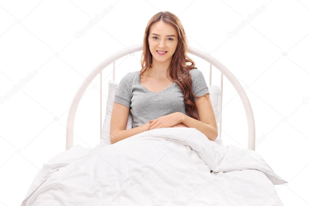 Woman lying in a bed covered with blanket