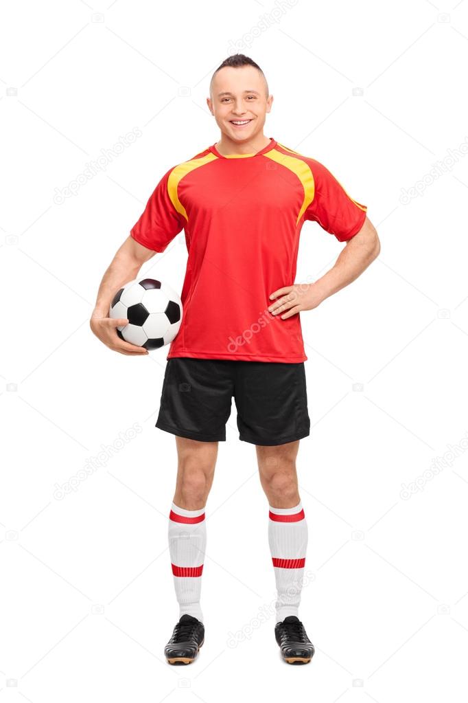 Young soccer player holding a ball