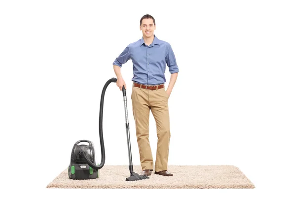 Man next to a vacuum cleaner — Stock Photo, Image