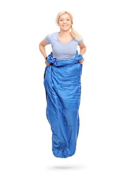 Blond woman jumping in a blue sack — Stock Photo, Image