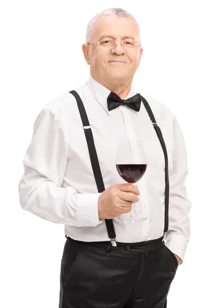 Senior herre håller ett glas vin — Stockfoto