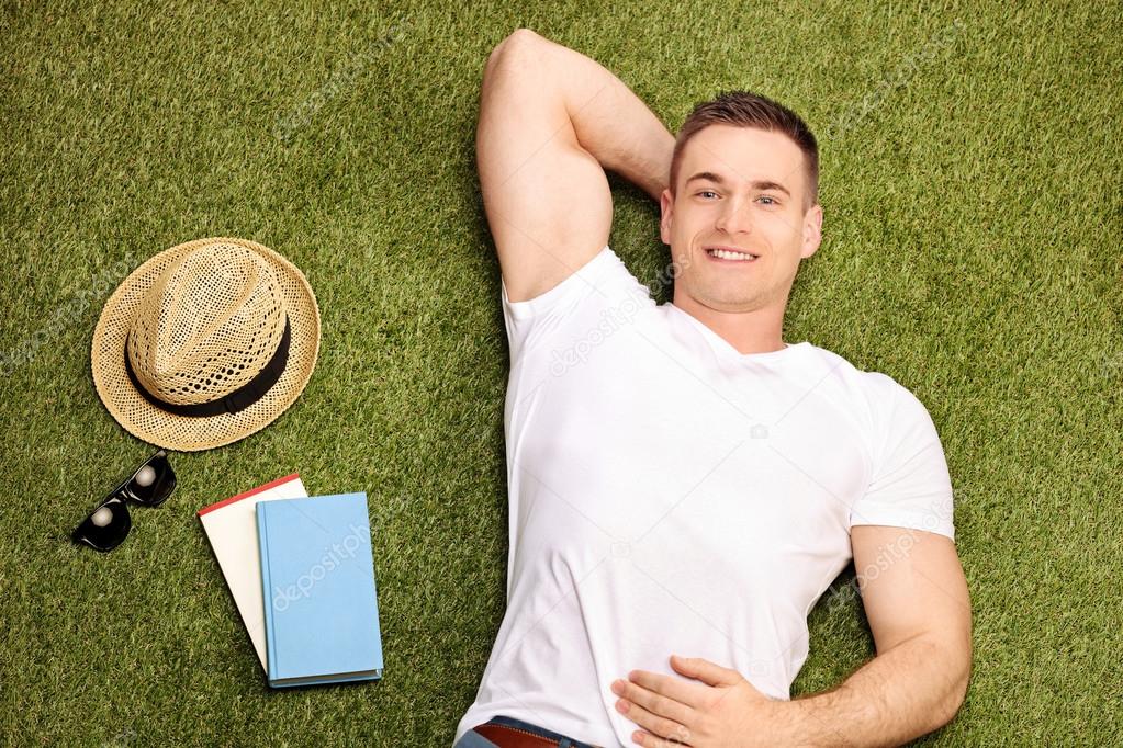 Carefree young man lying on grass