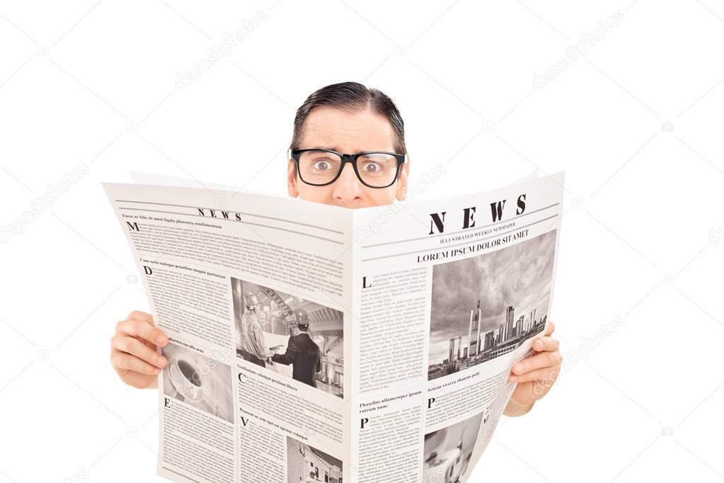 Terrified man reading a newspaper