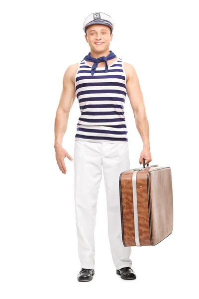 Bello marinaio con in mano una borsa marrone — Foto Stock