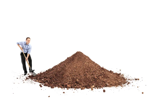 Man shoveling a big pile of dirt — Stock Photo, Image