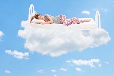 Woman sleeping in the clouds clipart