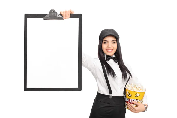 Woman holding popcorn and a clipboard — Stock Photo, Image