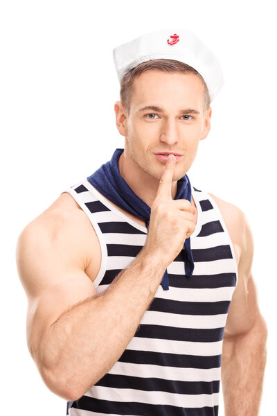 Handsome sailor holding finger on lips