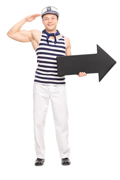 Manliga sjöman salutera och hålla en pil — Stockfoto