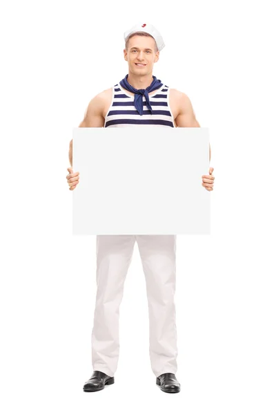 Hezký námořník drží prázdný nápis — Stock fotografie