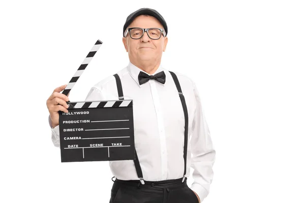 Mature movie director holding a clapperboard — Stock Photo, Image