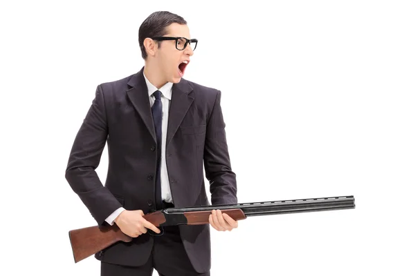 Angry man holding a rifle and shouting — Stock Photo, Image