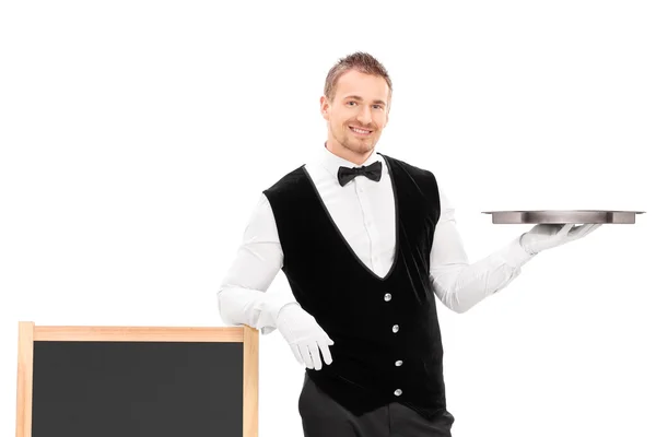 Male waiter holding an empty tray — Stock Photo, Image