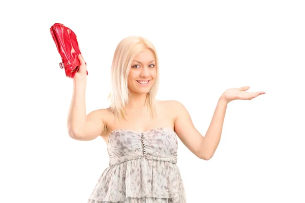 Blond woman holding a red purse — Stock Photo, Image