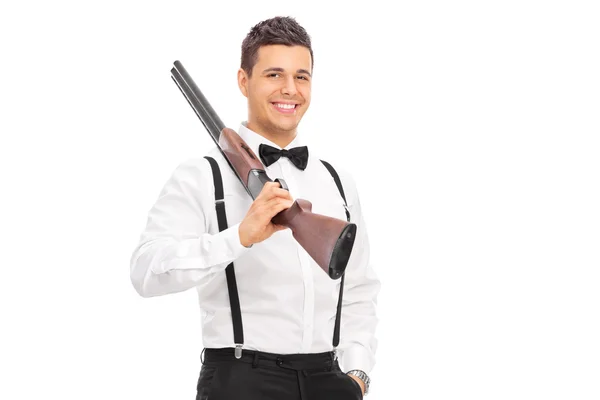 Elegant guy holding a shotgun — Stock Photo, Image