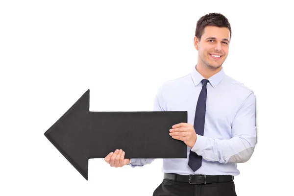 Businessman holding a big black arrow — Stock Photo, Image