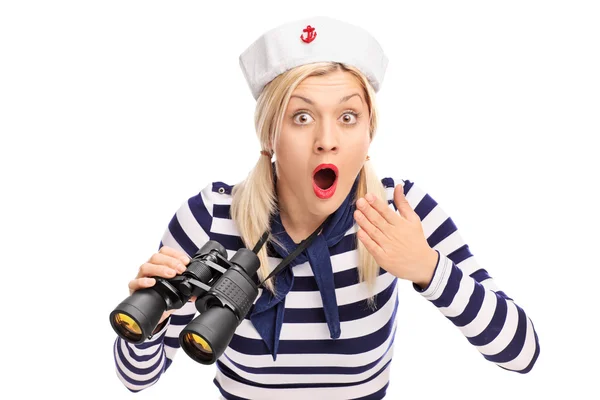 Surprised female sailor holding binoculars — Stock Photo, Image