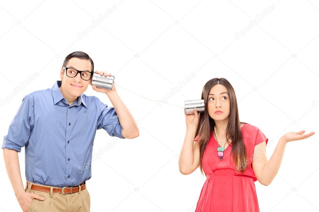 Couple talking through a tin can phone
