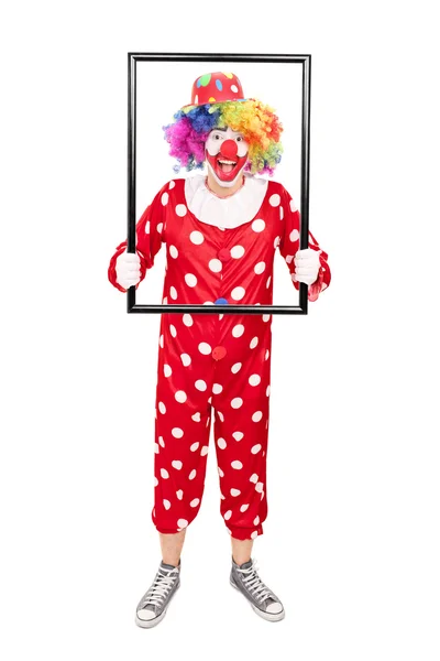 Mannelijke clown houden een afbeeldingsframe — Stockfoto