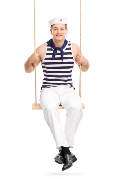 Young male sailor sitting a swing — Stock Photo, Image