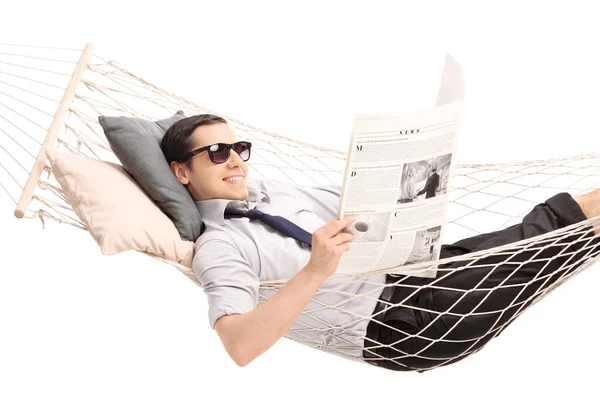 Man reading a newspaper and in a hammock — Stock Photo, Image