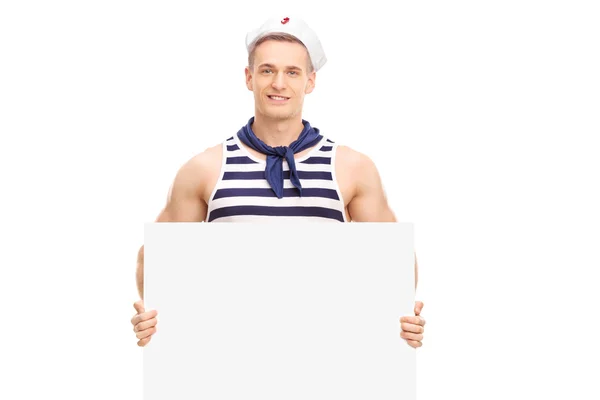 Handsome sailor holding a blank banner — Stock Photo, Image