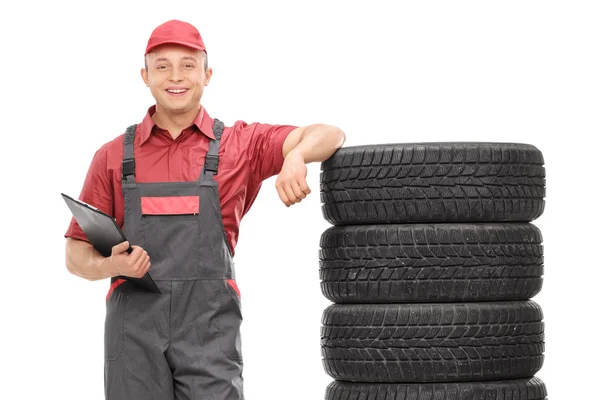 Young male mechanic in a gray jumpsuit — Stock Photo, Image