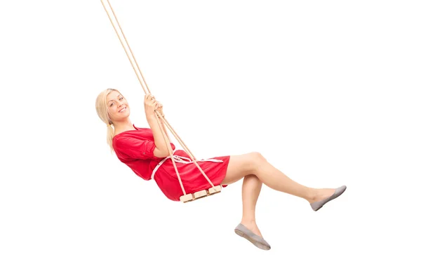 Woman with hat swinging on a swing — Stock Photo, Image