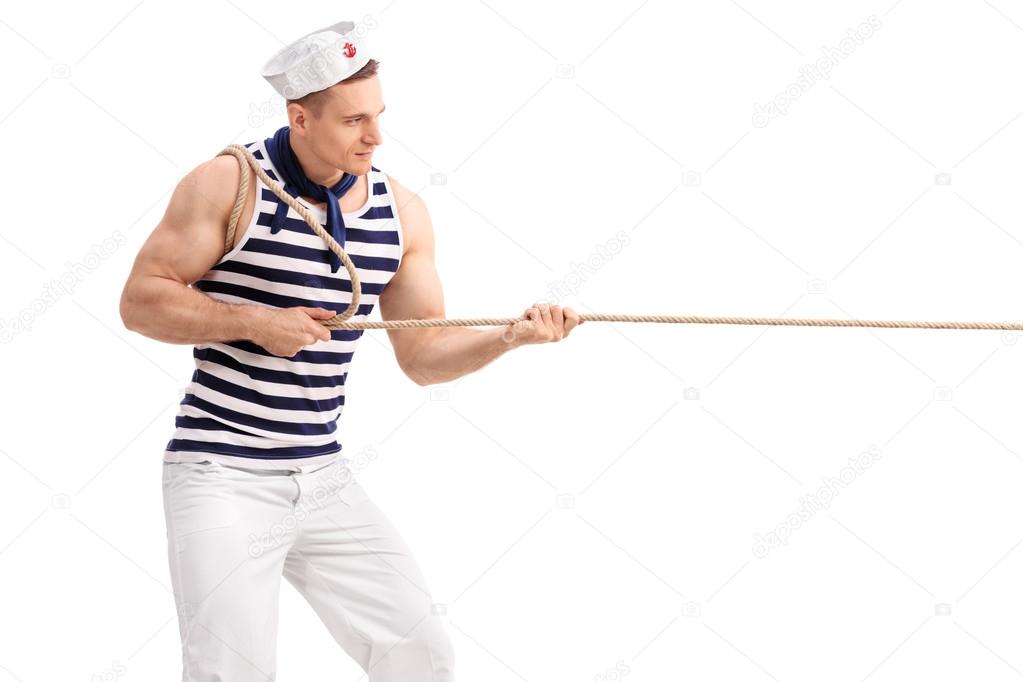 man in sailor uniform pulling a rope