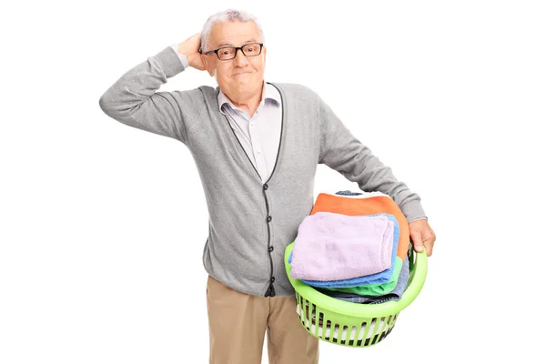 Senior man holding a laundry basket — Stock Photo, Image