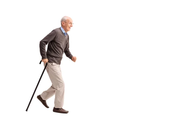 Homem sênior andando rápido com uma bengala — Fotografia de Stock