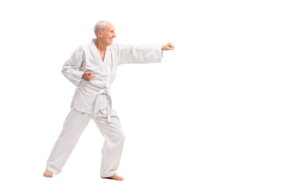 Old man in kimono practicing karate
