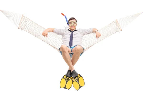 Man with diving fins lying in a hammock — Stock Photo, Image