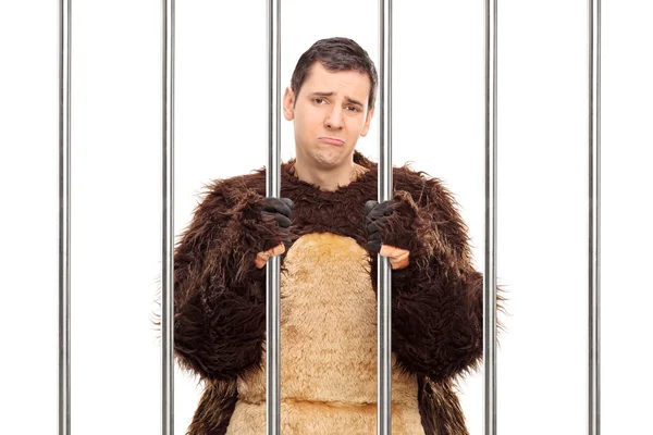 Man in a bear costume behind bars — Stock Photo, Image