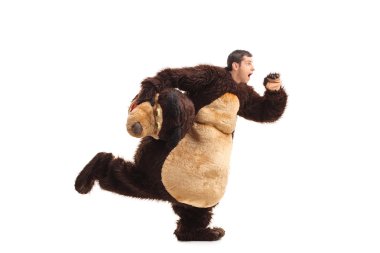 Horrified man in a bear costume running  clipart