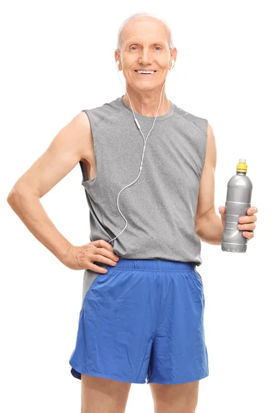Senior man in sportswear holding a water — Stock Photo, Image