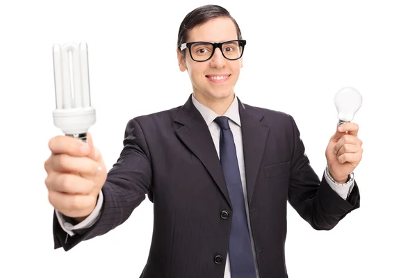 Man holding two light bulbs — Stock Photo, Image