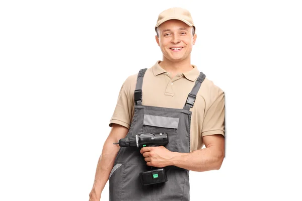 Trabalhador em uniforme segurando uma broca de mão — Fotografia de Stock