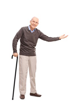 Senior with a cane gesturing with his hand 