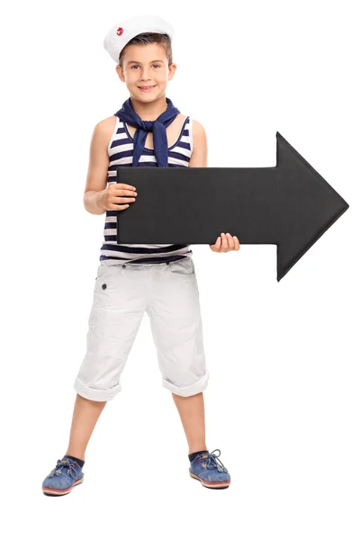 Boy in sailor outfit holding a arrow — Stockfoto