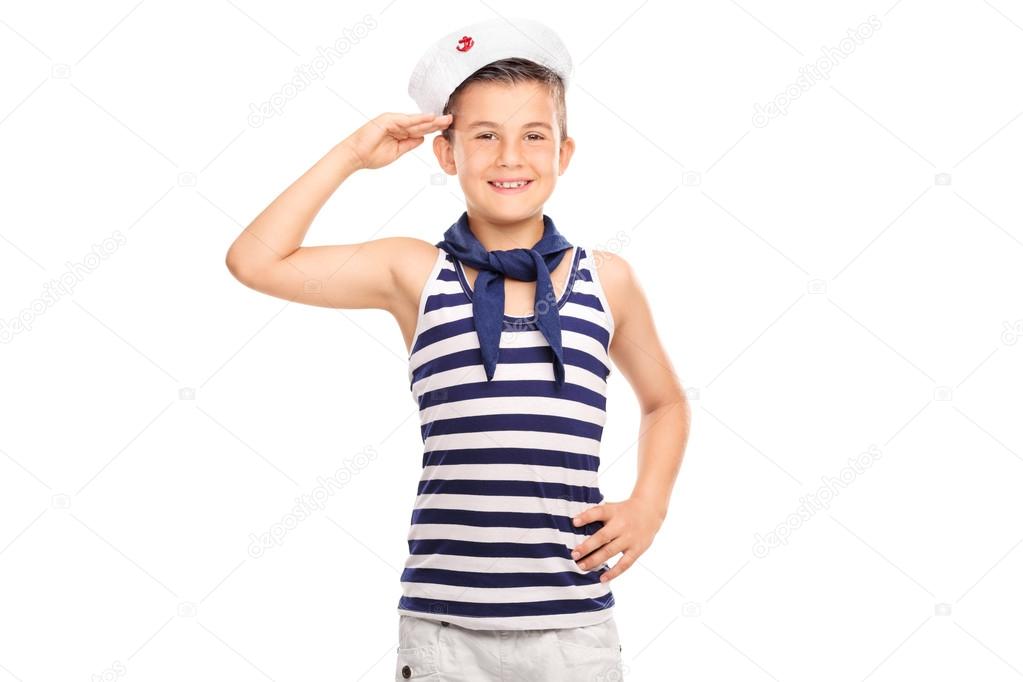 Joyful little boy in a sailor uniform saluting 