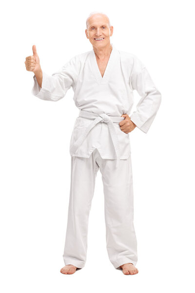 Senior man in a white kimono giving a thumb up 