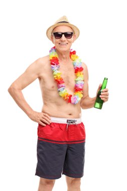 Senior man in a swim trunks holding a beer 