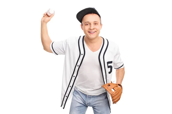 Cheerful young man throwing a baseball — Stok fotoğraf